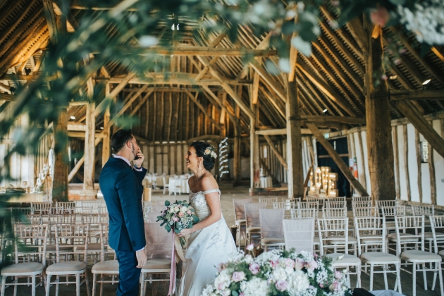 Couple laugh inside Cressing Temple Barns alone