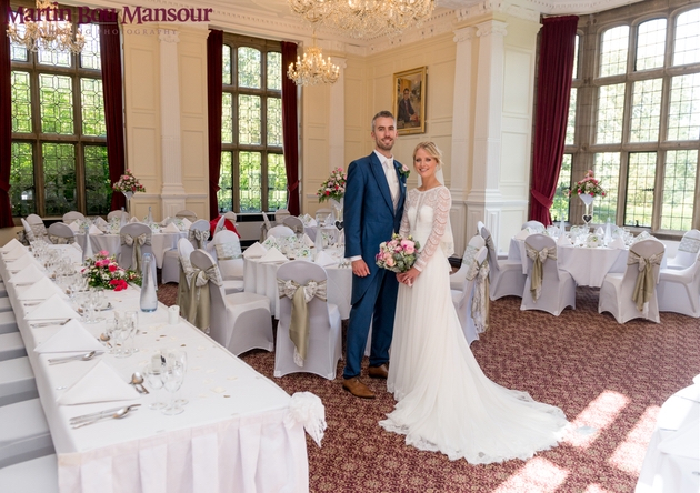 Wedded couple pose in the ornate rooms Putteridge Bury
