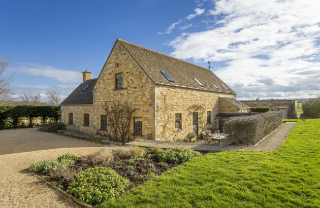 Yellow-wash stone cottage in garden