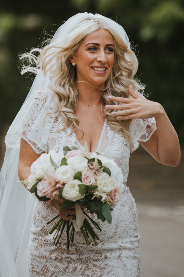 Bride with a beautiful bouquet by The Flower Bee 