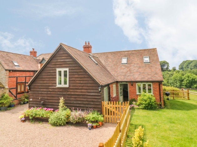 cosy cottage with grass and fence