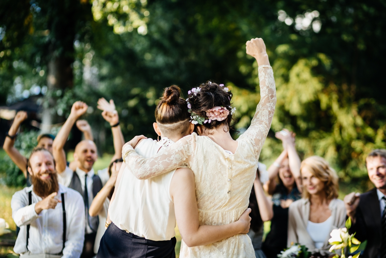 couple back to camera fist pump air