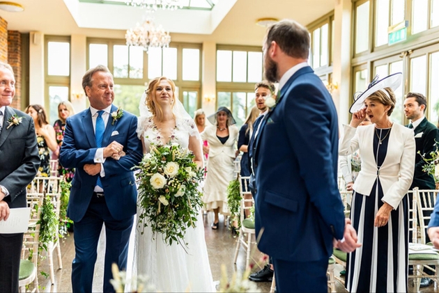 Father-of-the-bride walks up the aisle with his daughter