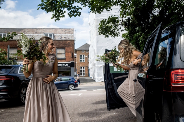 Bridesmaids getting out of wedding car