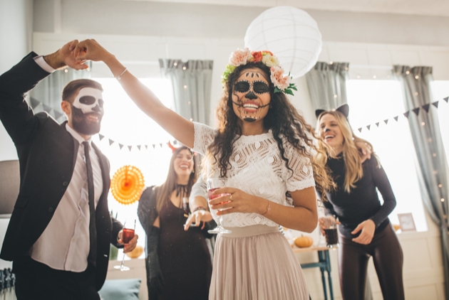 group of men and women dancing in the living room