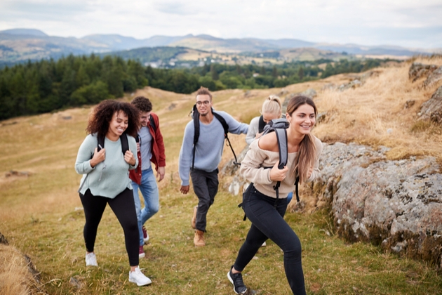 group of males and females walking up a hillside