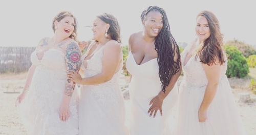 group of curvy models all in wedding dresses standing outside 