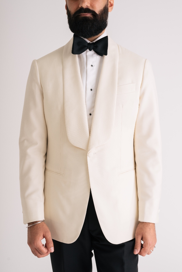 Gent in a white tux with black bow tie