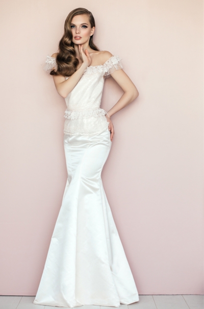 bride in a french style wedding dress against a pink background