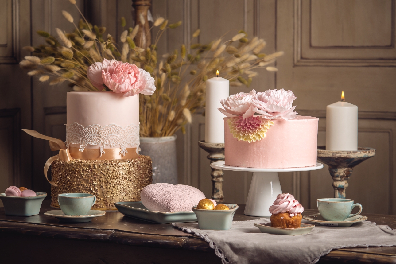 cake display of pink and gold cakes