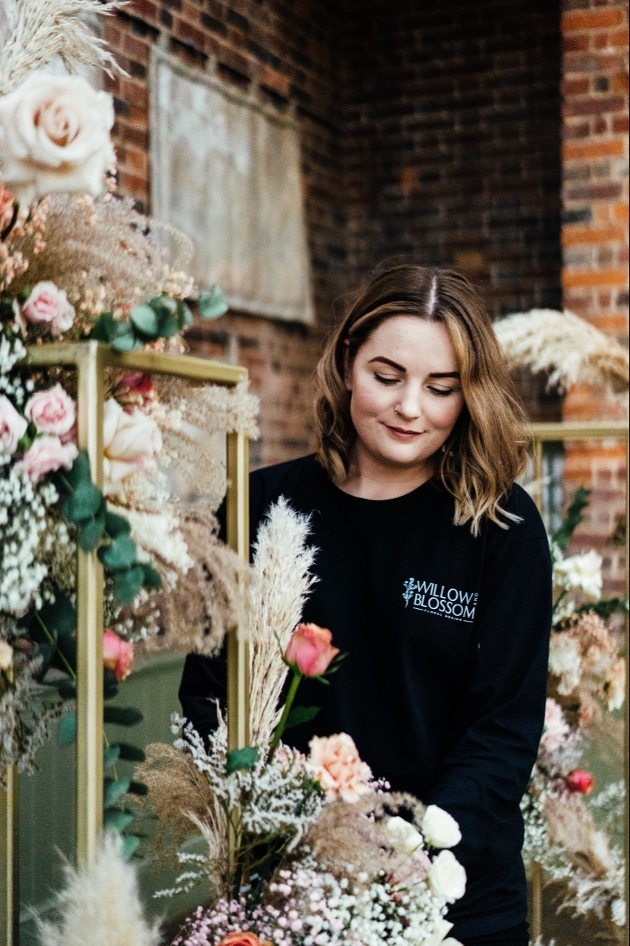 florist tending to flowers in a shop