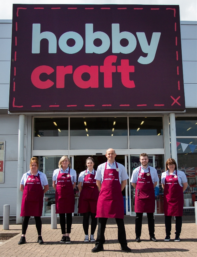 Hobbycraft workers in their uniform standing outside shop