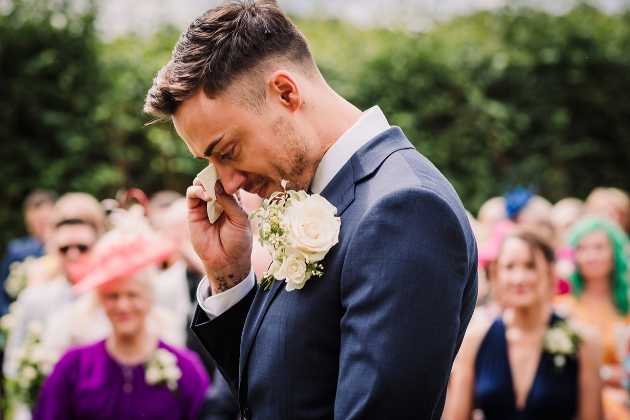 Groom wiping a tear