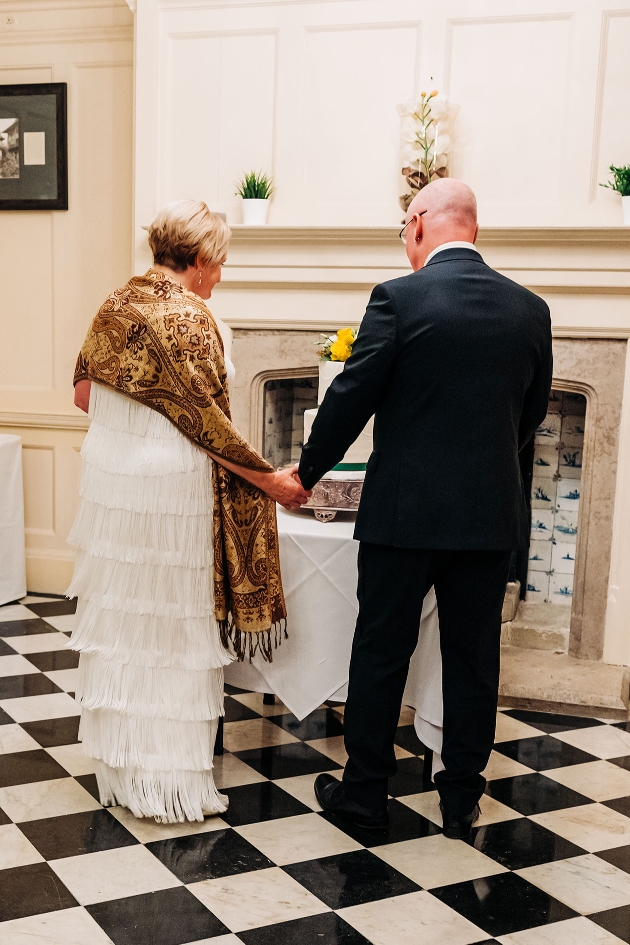 Couple admiring wedding cake