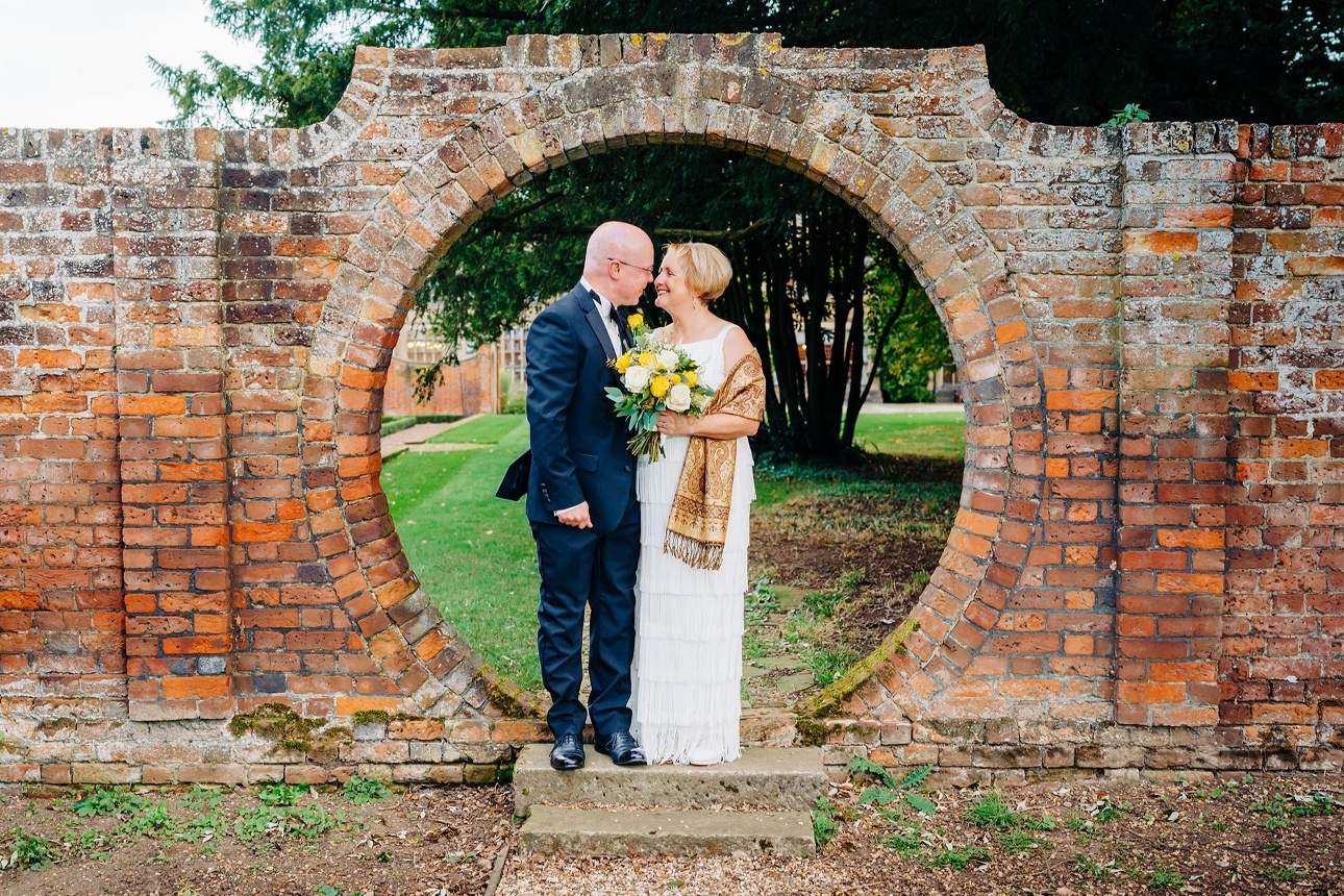 Bride and groom under arch