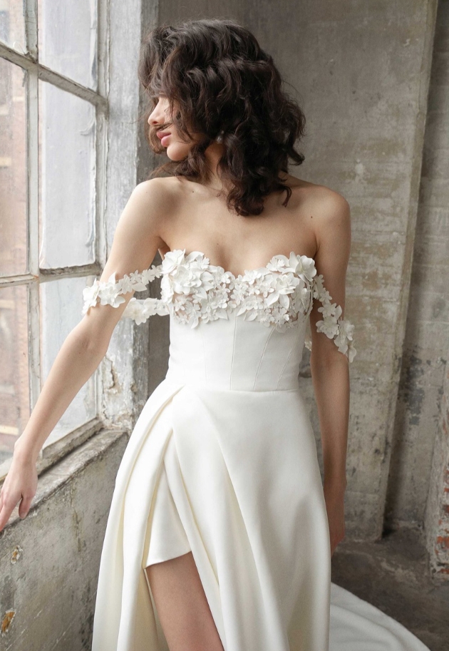 model in off shoulder gown with floral applique detailing over bust and straps