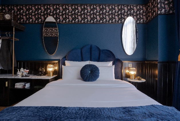 large bed in rooms with blue eclecetic decor