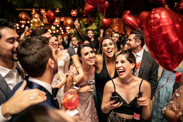 people on dance floor with red heart balloons