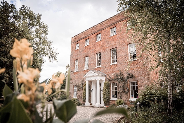 pretty country manor house with gravel drive white stucco doorway