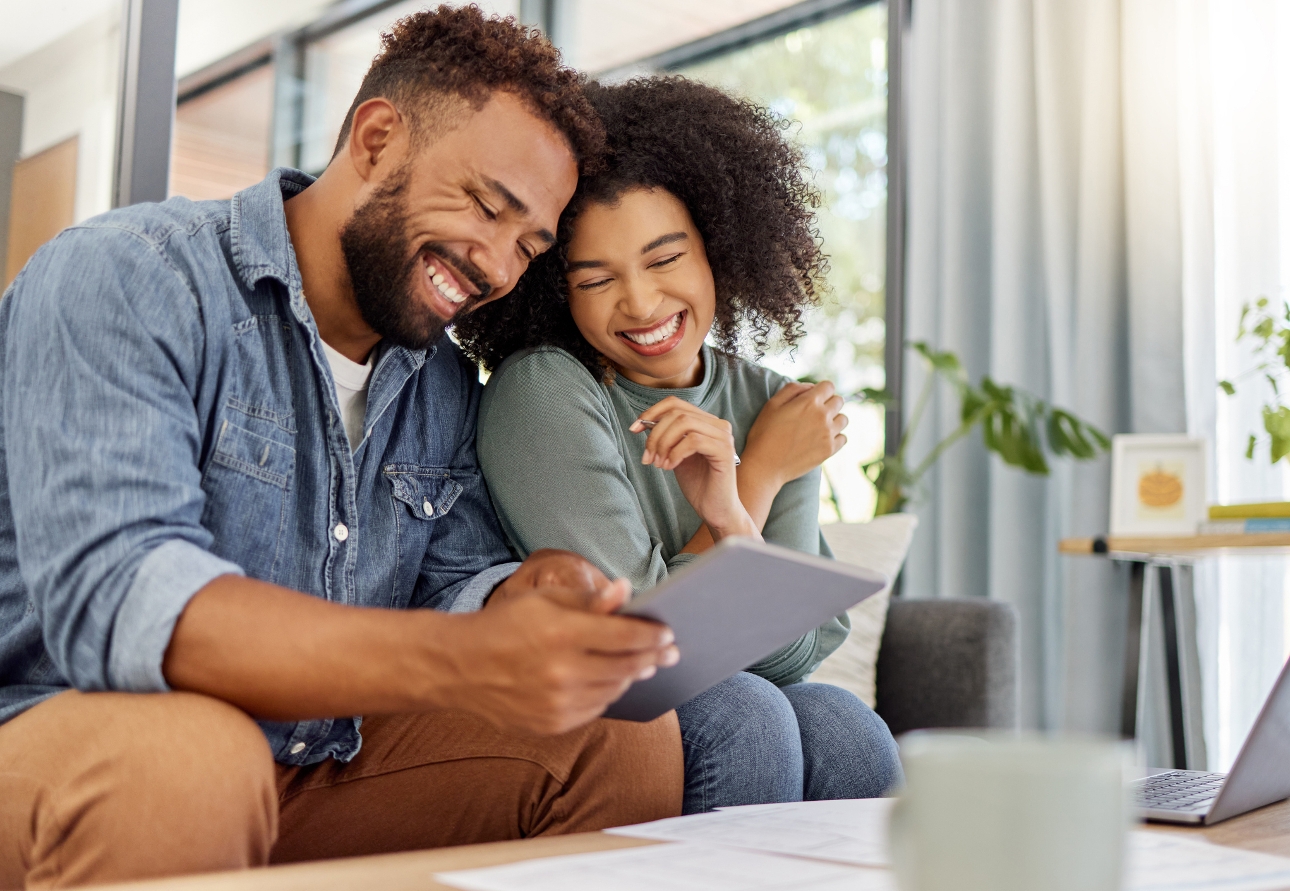 couple on sofa looking at ipad