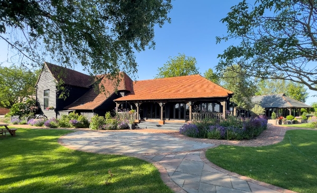 old barn in manicured gardens