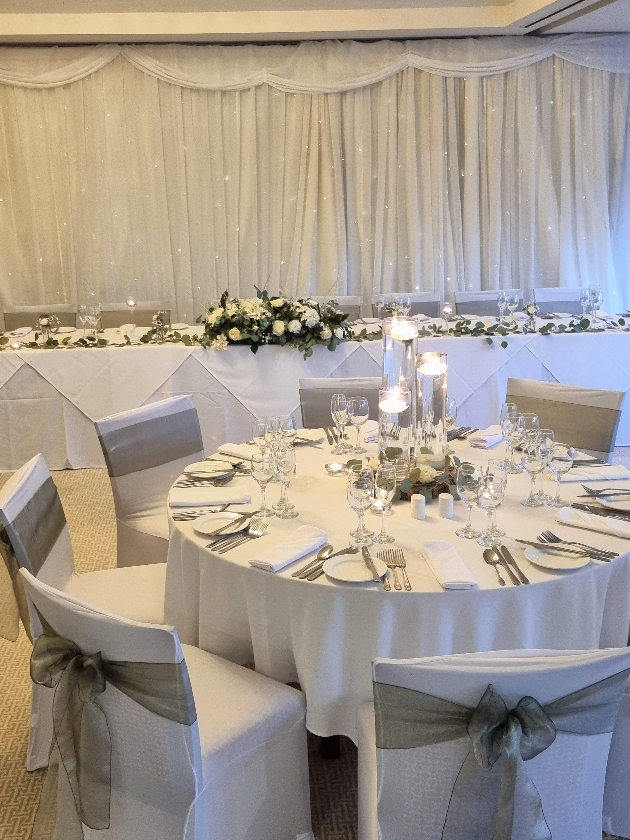 reception room, white chairs and tables, with grey sashes