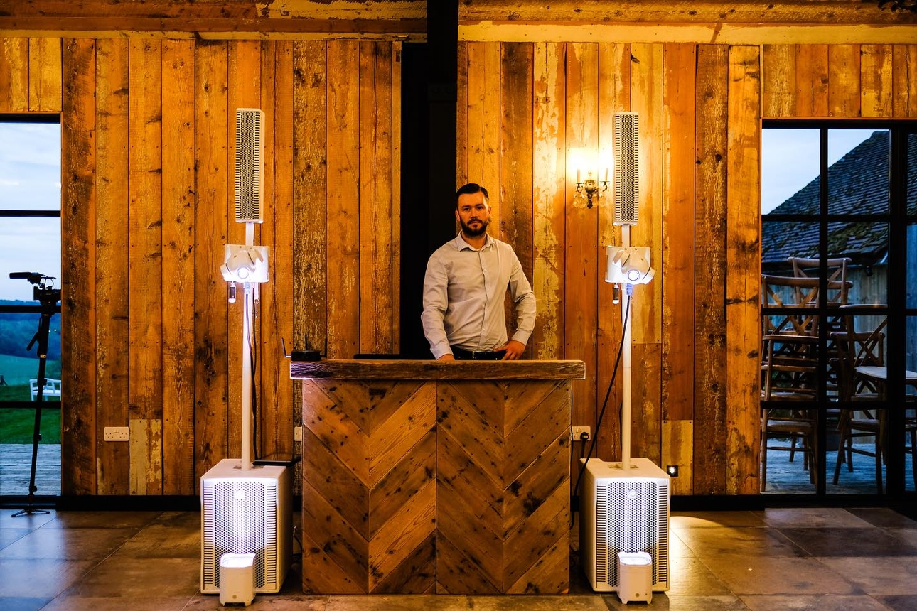 DJ behind a wooden DJ booth