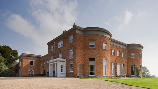 red brick venue with circular corners, grand white pillar entrance 