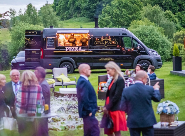 pizza van in a field at an outdoor wedding reception