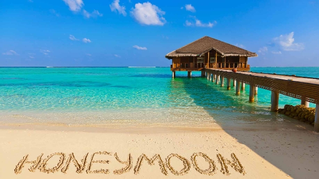 tropical destination, with honeymoon written in sand