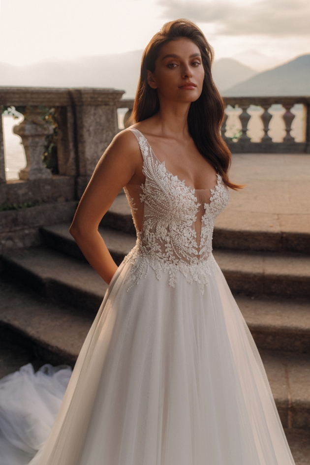 model in intricate bodice, with lace and sheer detail into ball skirt