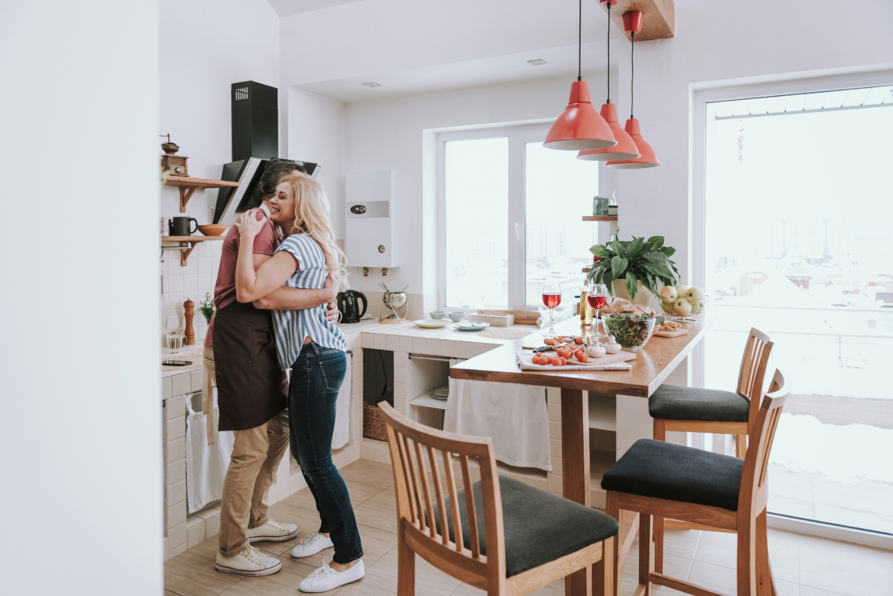 couple dancing in the kitchen dinner on the table