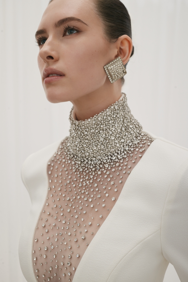 Long Sleeve Gown in ivory is captivating, adorned with intricate diamante embellishments.