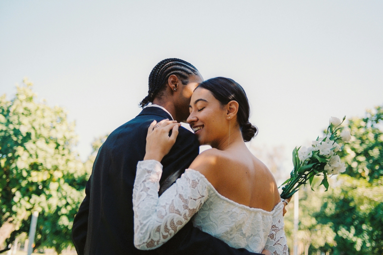 couple embracing on their wedding day outdoors